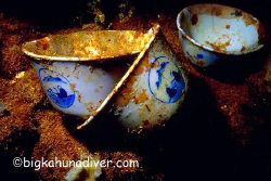 China tea cups aboard the unkai maru #6-Nikonos v 35mm cl... by Mike Ellis 